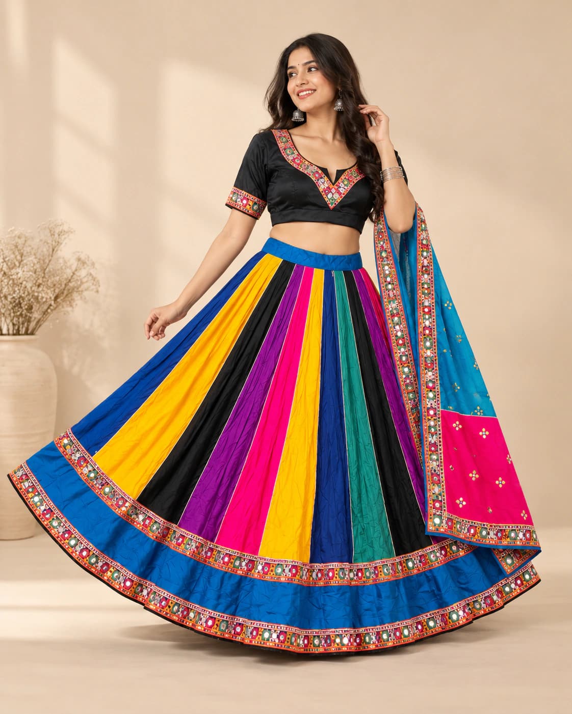 Navrang Blue: A black-ground lehenga energised by vertical yellow, pink, blue, green and orange panels and a multicolour folk border.