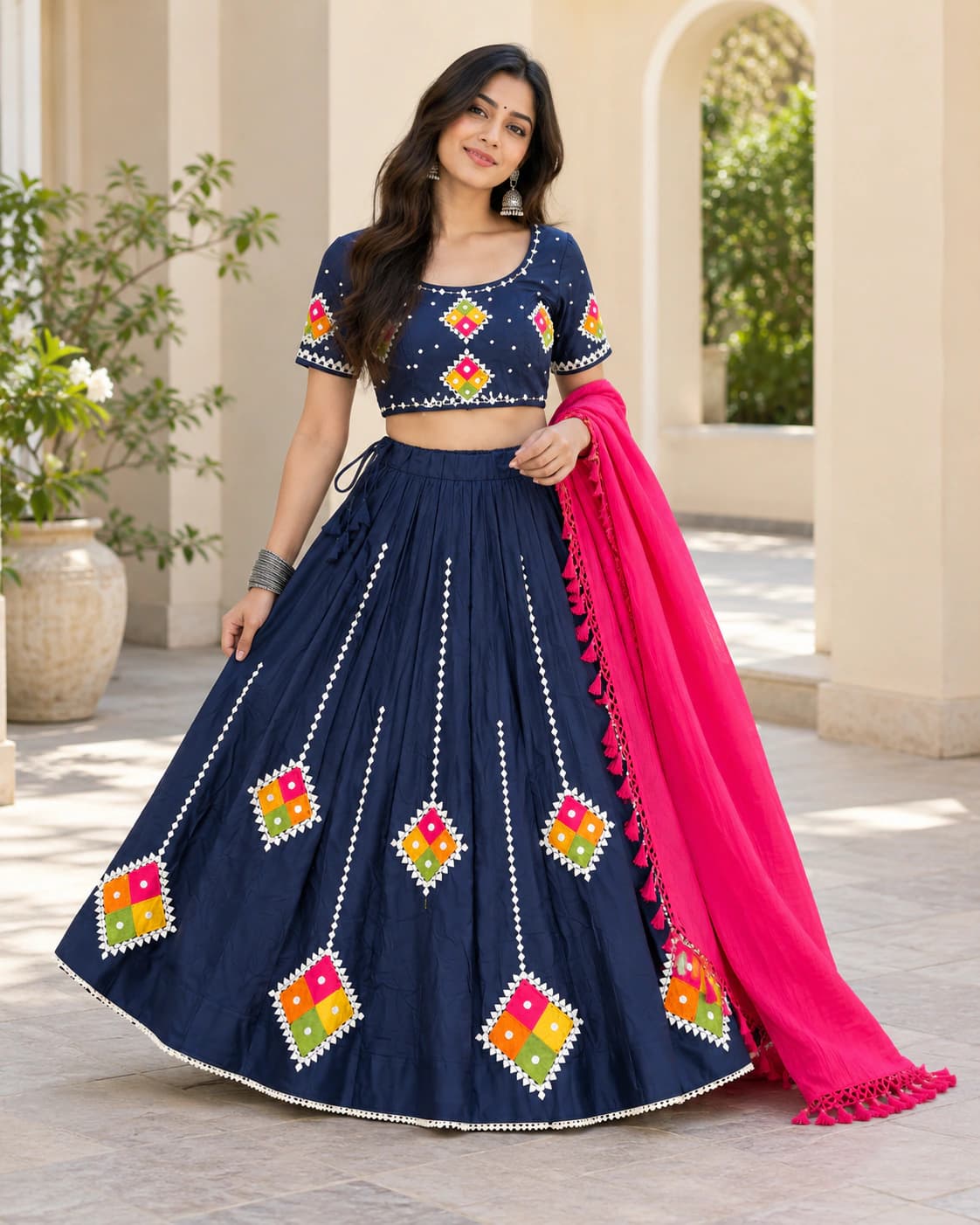 Indigo Night: A deep navy set dotted with colourful diamond-shaped folk motifs and finished with a bright pink contrast dupatta.