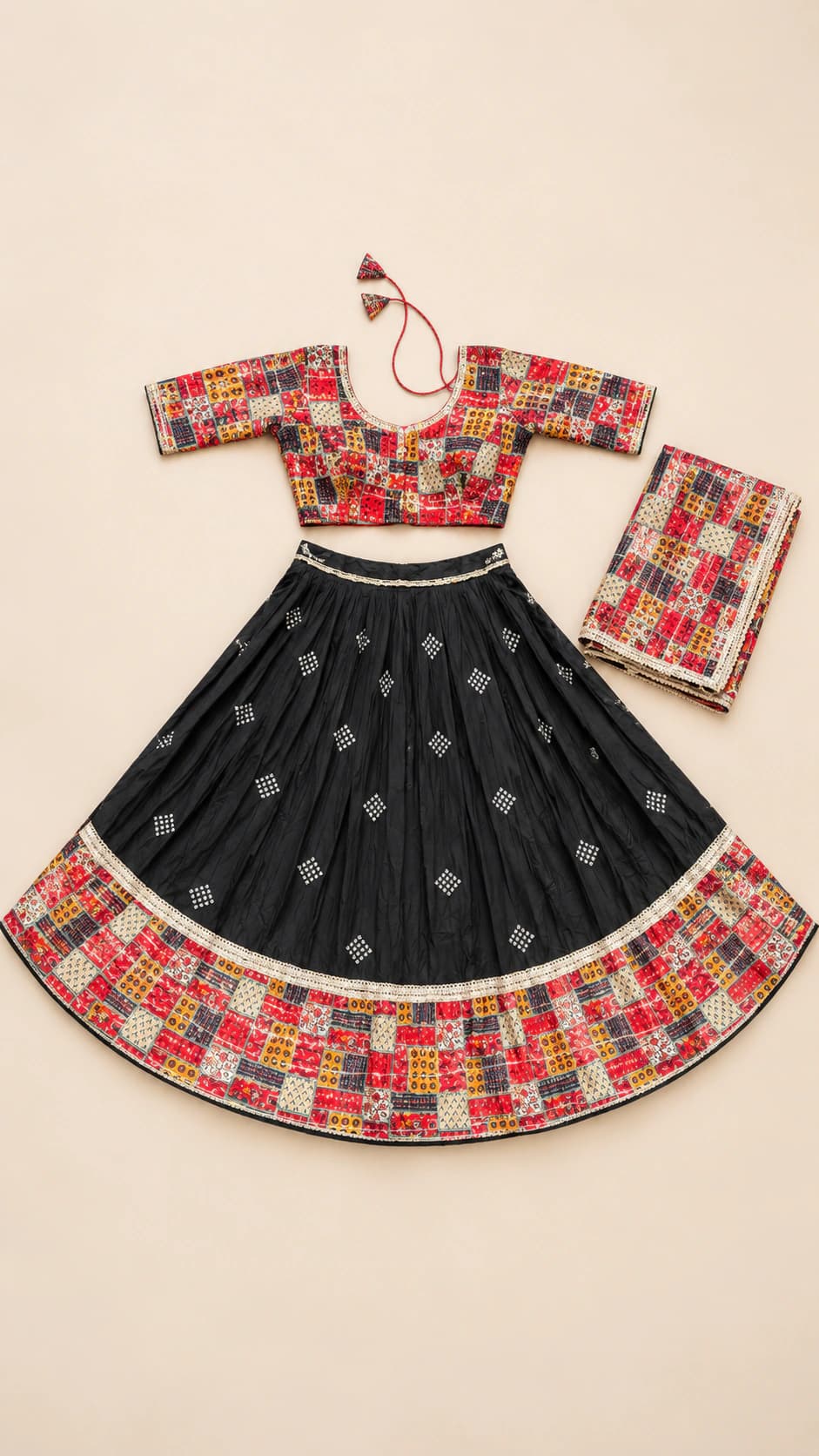 Midnight Mosaic: A black flared chaniya choli framed with richly coloured geometric mosaic borders across the blouse, hem and matching dupatta.