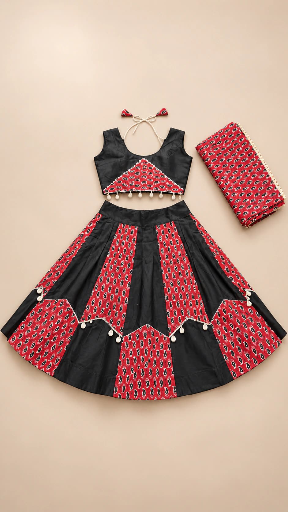 Scarlet Rhythm: A dramatic black and scarlet set with alternating skirt panels, patterned red insets and a sharp scalloped border treatment.