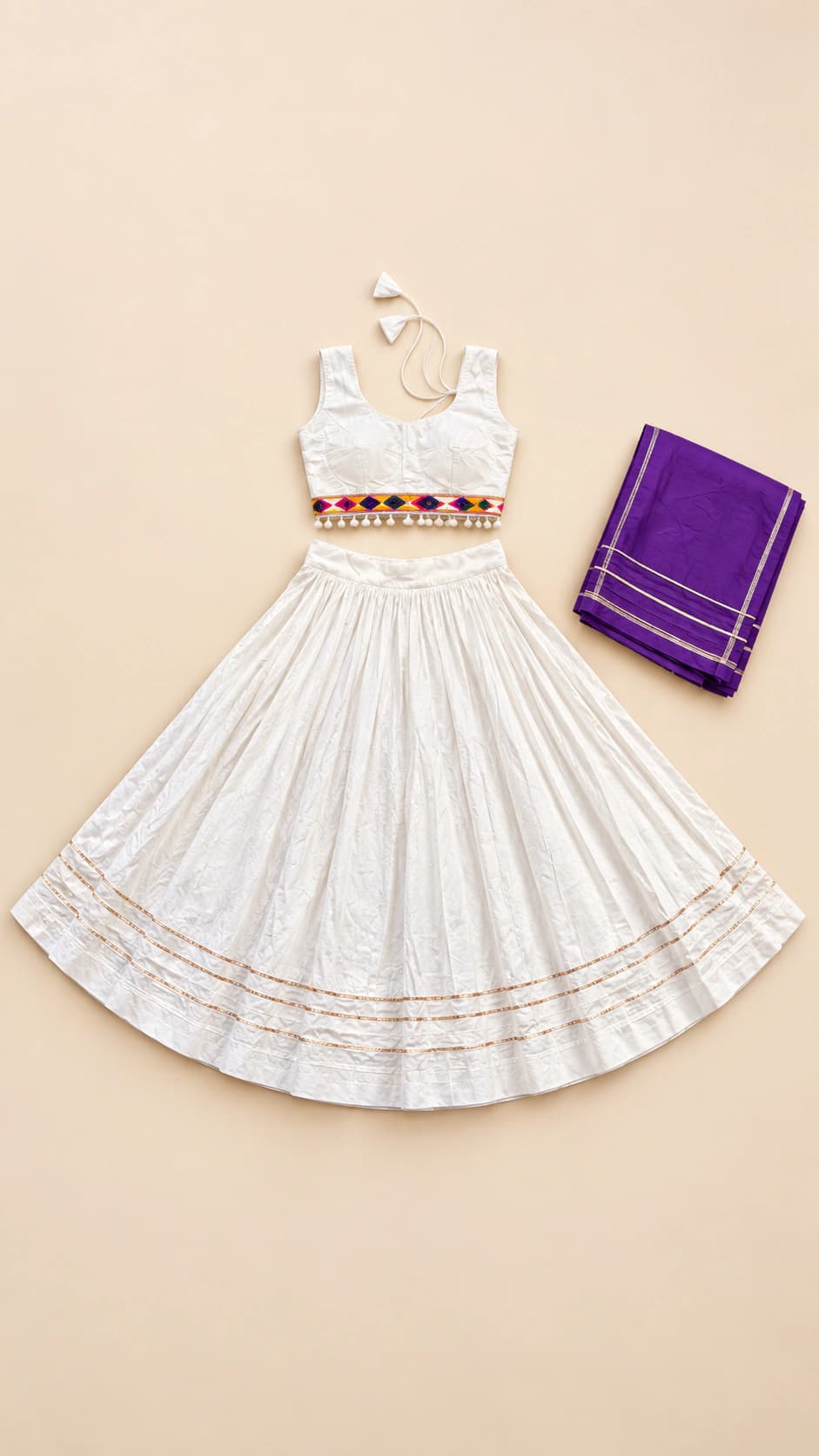 Moonlit Ivory: An understated ivory ensemble with delicate linear hem detailing, a sleeveless blouse and a regal purple contrast dupatta.