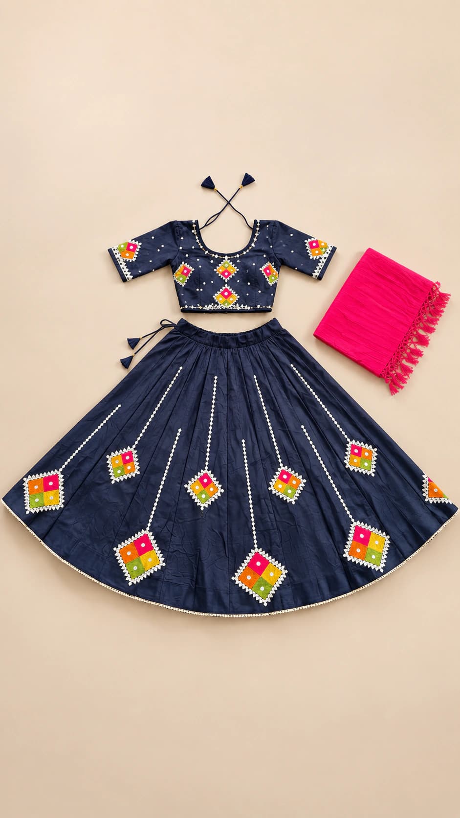 Indigo Night: A deep navy set dotted with colourful diamond-shaped folk motifs and finished with a bright pink contrast dupatta.