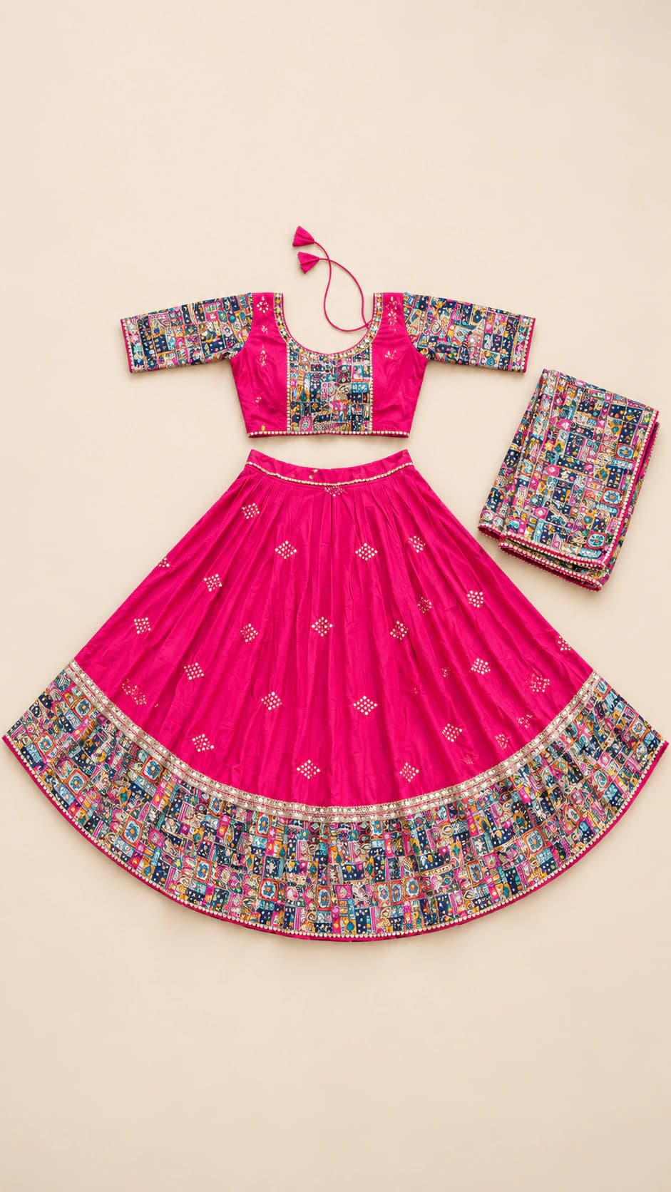 Gulabi Garden: A vivid pink chaniya choli with tiny scattered motifs and an expansive multicolour floral-folk border repeated on the blouse and dupatta.
