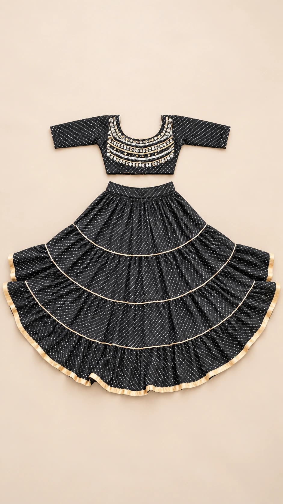 Black Pearl: A sophisticated black ensemble with closely patterned fabric, two sweeping tiers and metallic-toned trim for a crisp festive finish.