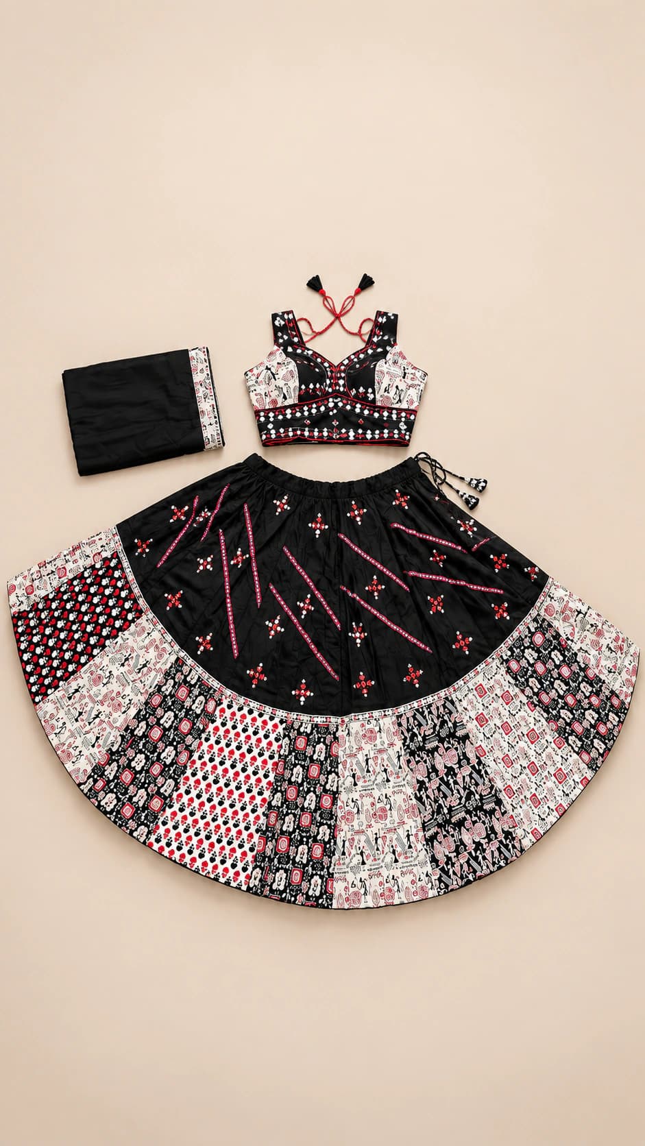 Noir Rosette: A black Garba set featuring pink line motifs, a decorative blouse and a broad patchwork-style skirt border in black, ivory and rose.