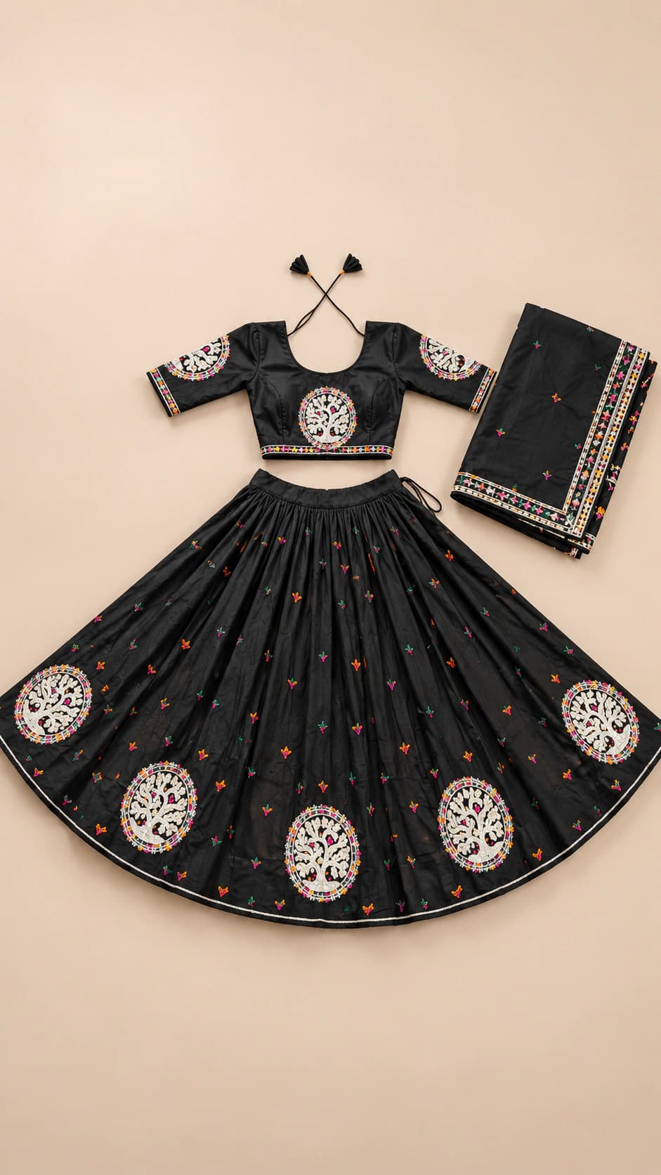 Moonlit Black: A graceful black ensemble with circular ivory medallions around the hem, scattered rust accents and a coordinating dark dupatta.