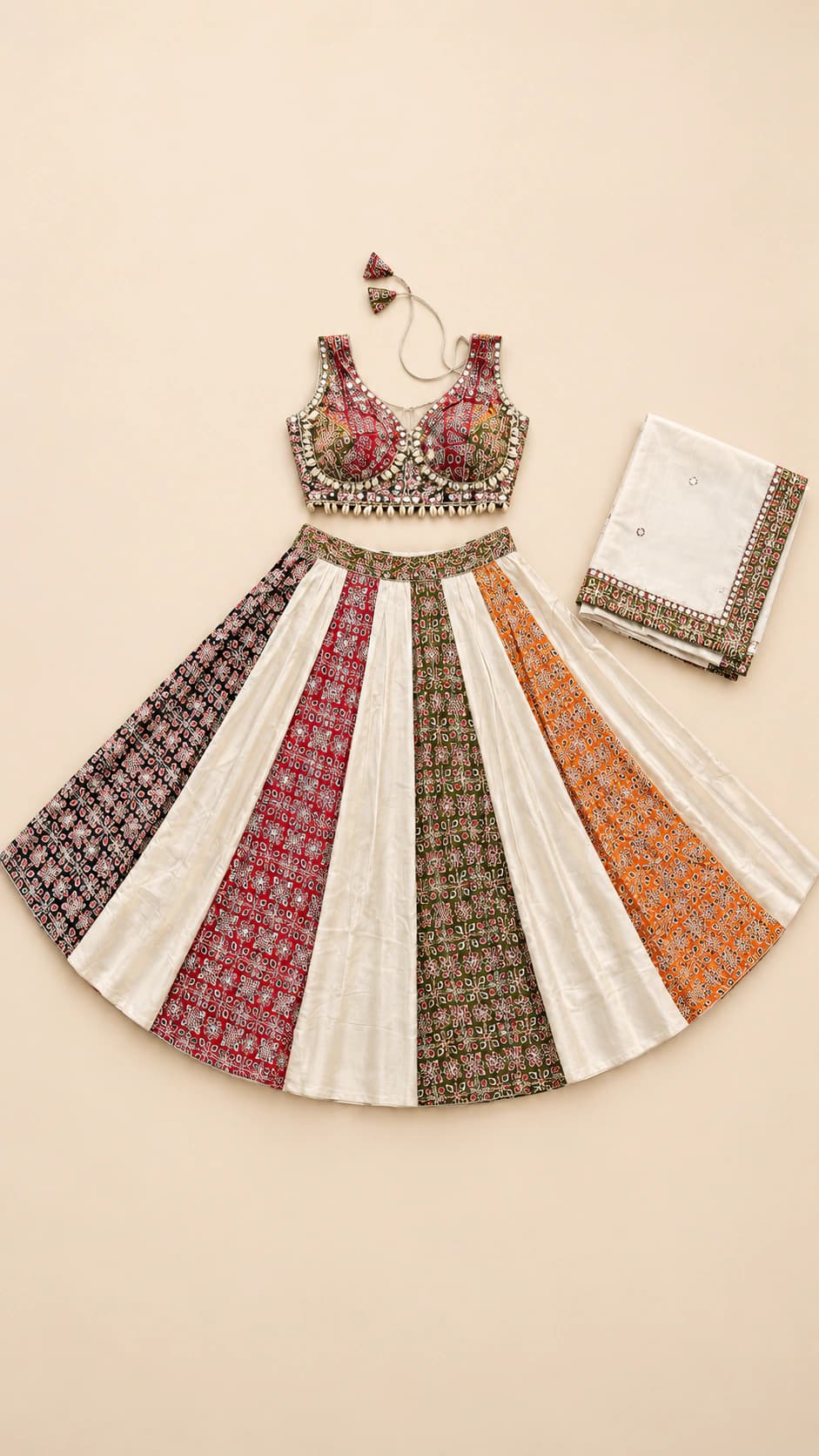 Terracotta Muse: An ivory-led panelled lehenga alternating terracotta and charcoal patterns, paired with a densely decorated sleeveless blouse.