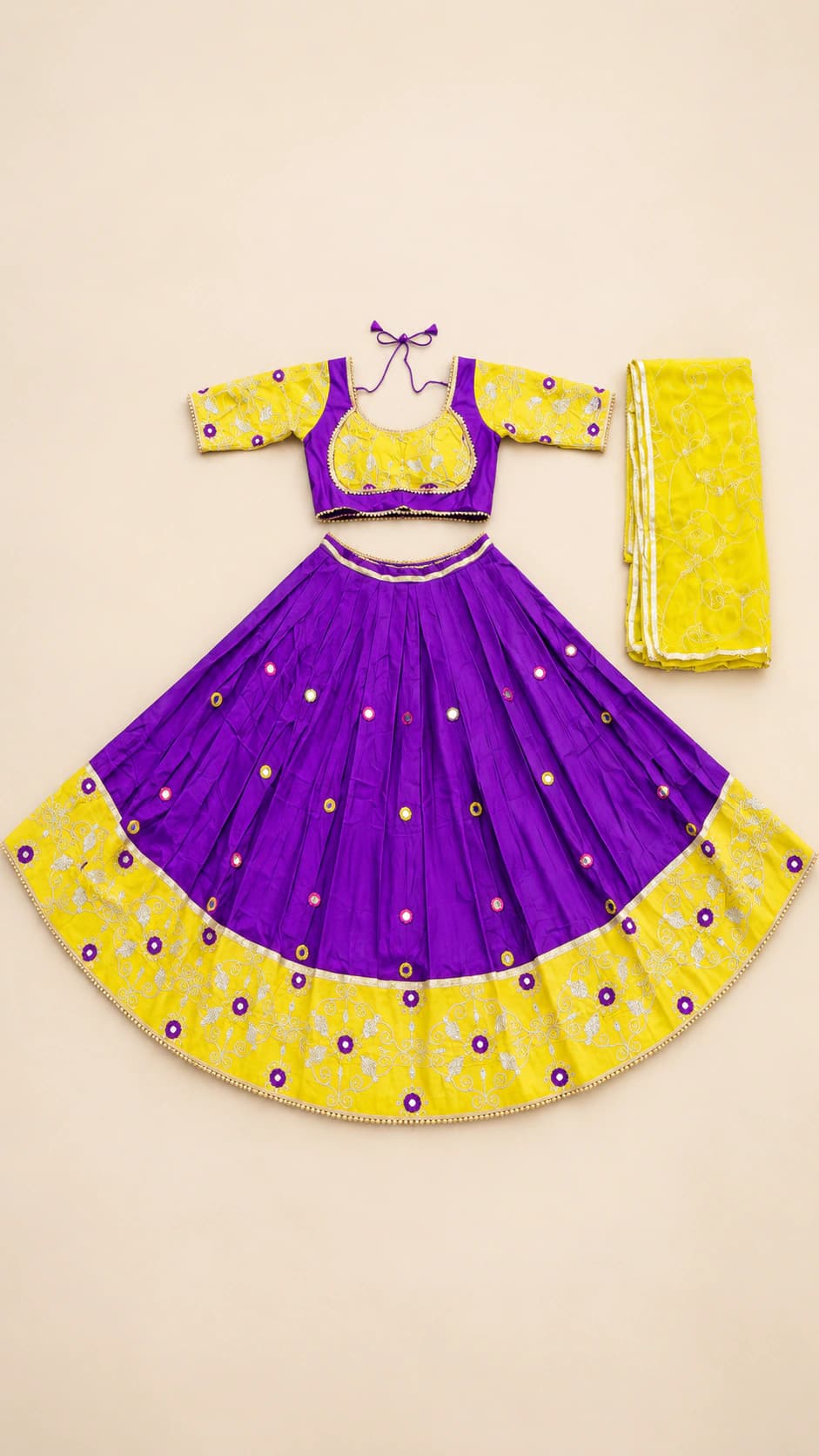 Dandiya Dusk: A bold violet and yellow combination with bright motif accents, a contrast blouse and a wide marigold patterned hem.
