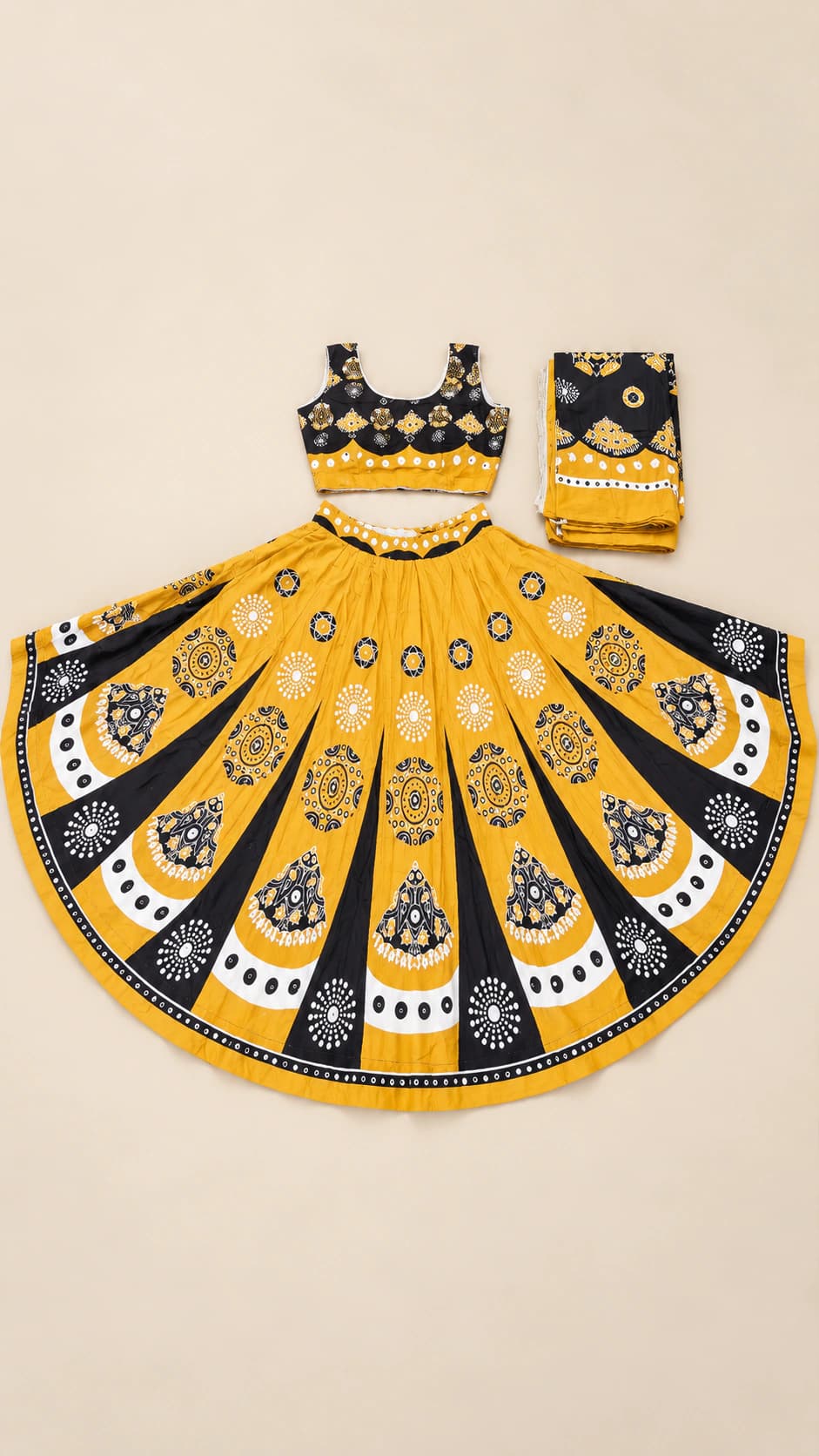 Peacock Gold: A statement marigold lehenga with bold black-and-ivory teardrop motifs, scalloped panel framing and a coordinated dark dupatta.