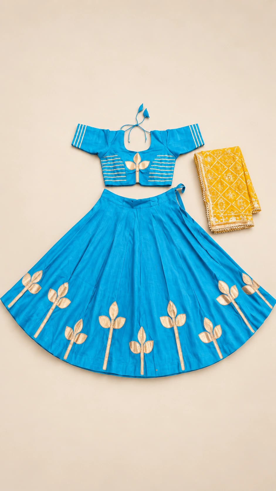 Turquoise Lotus: A clear turquoise set with a cropped short-sleeve blouse, ivory lotus-like motifs and a warm gold-toned dupatta.