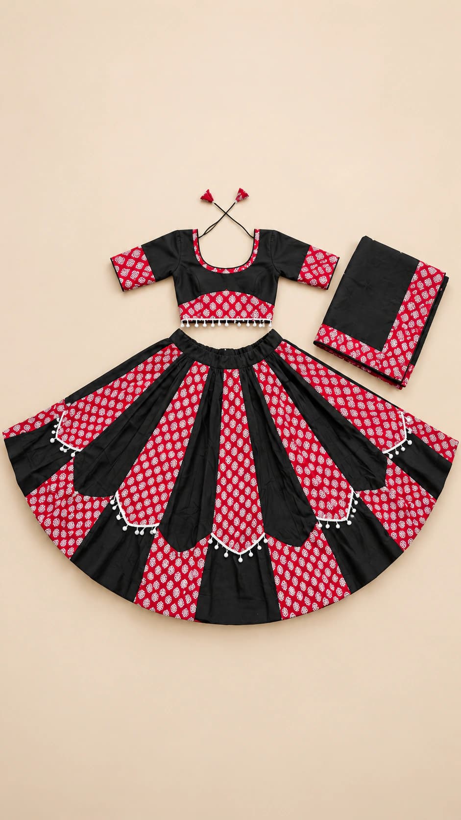 Petal Play: A playful pink-and-black set with large petal-shaped skirt panels, a patterned crop blouse and a coordinating block-print dupatta.