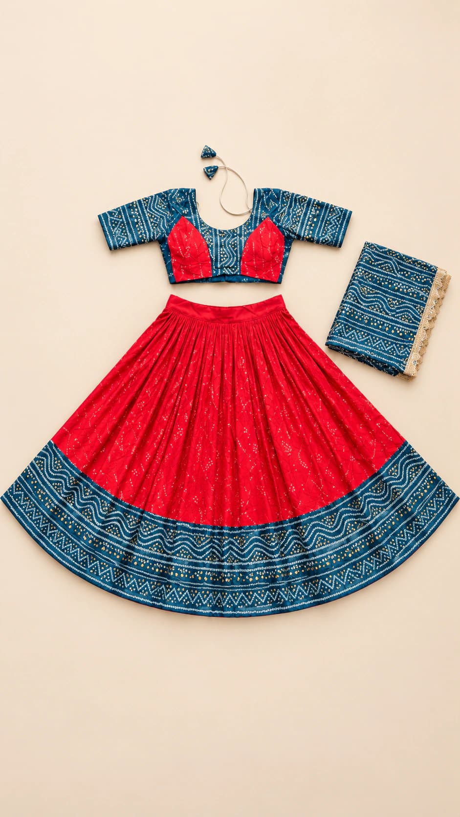 Scarlet Teal: A bright scarlet lehenga grounded by a wide teal patterned hem, paired with a teal-and-red blouse and matching dupatta.