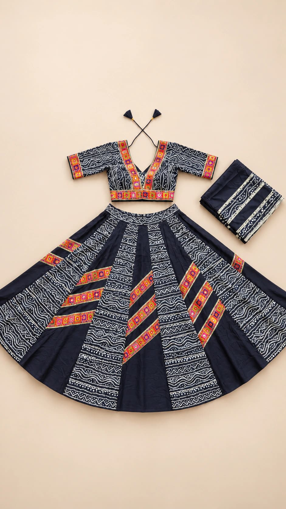 Indigo Ember: A deep indigo folk set with orange patterned panel bands, a richly detailed short-sleeve blouse and a matching dark dupatta.