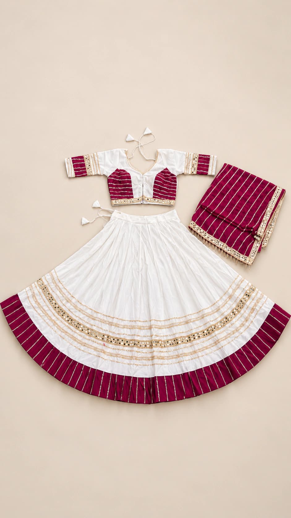 Ivory Wine: An elegant ivory lehenga with wine-red blouse panels, fine gold-toned decorative bands and a coordinating striped wine dupatta.